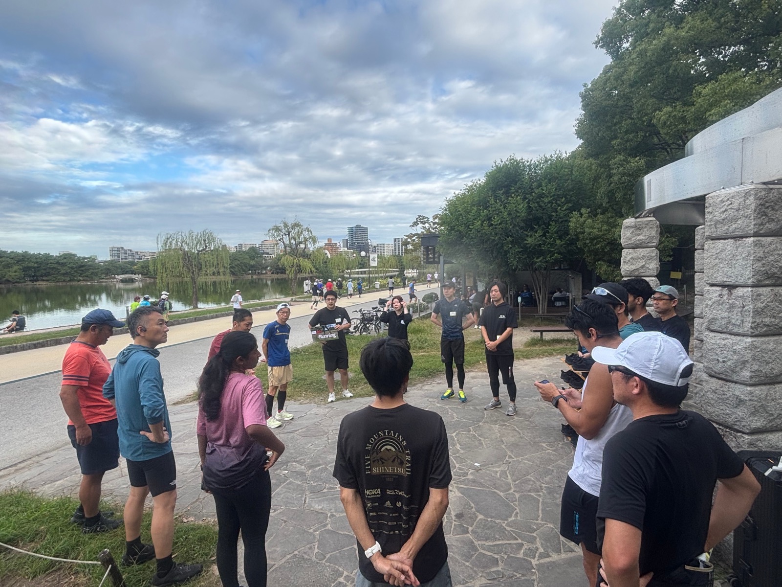 Morning-run participants gathering beside the pond at Ohori Park